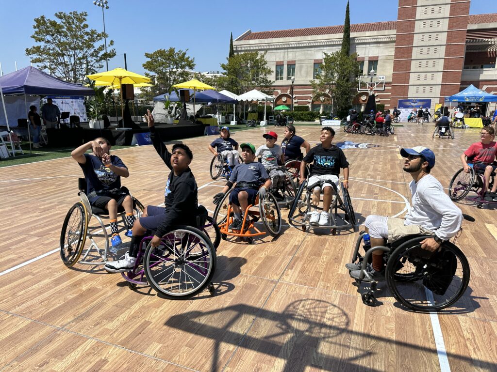 Kids are playing wheelchair basketball outside