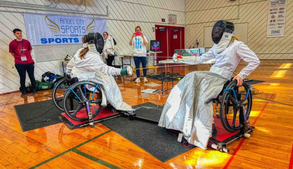 Two young women fencing in wheelchairs