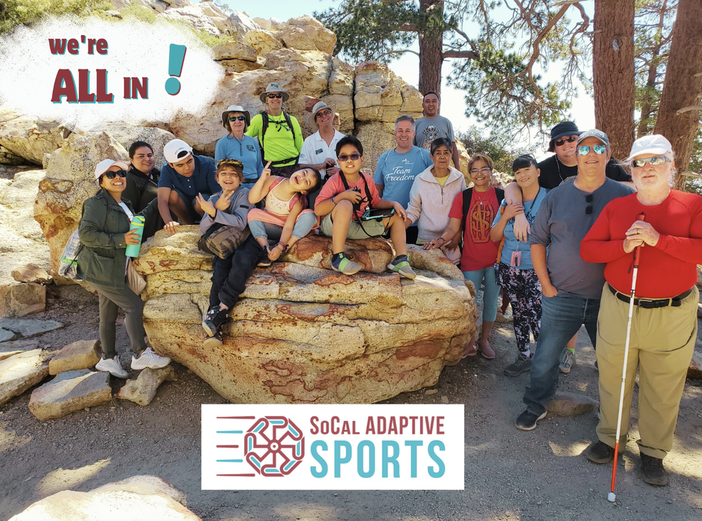 A group of people with disabilities at a socall adaptive sports events with their logo